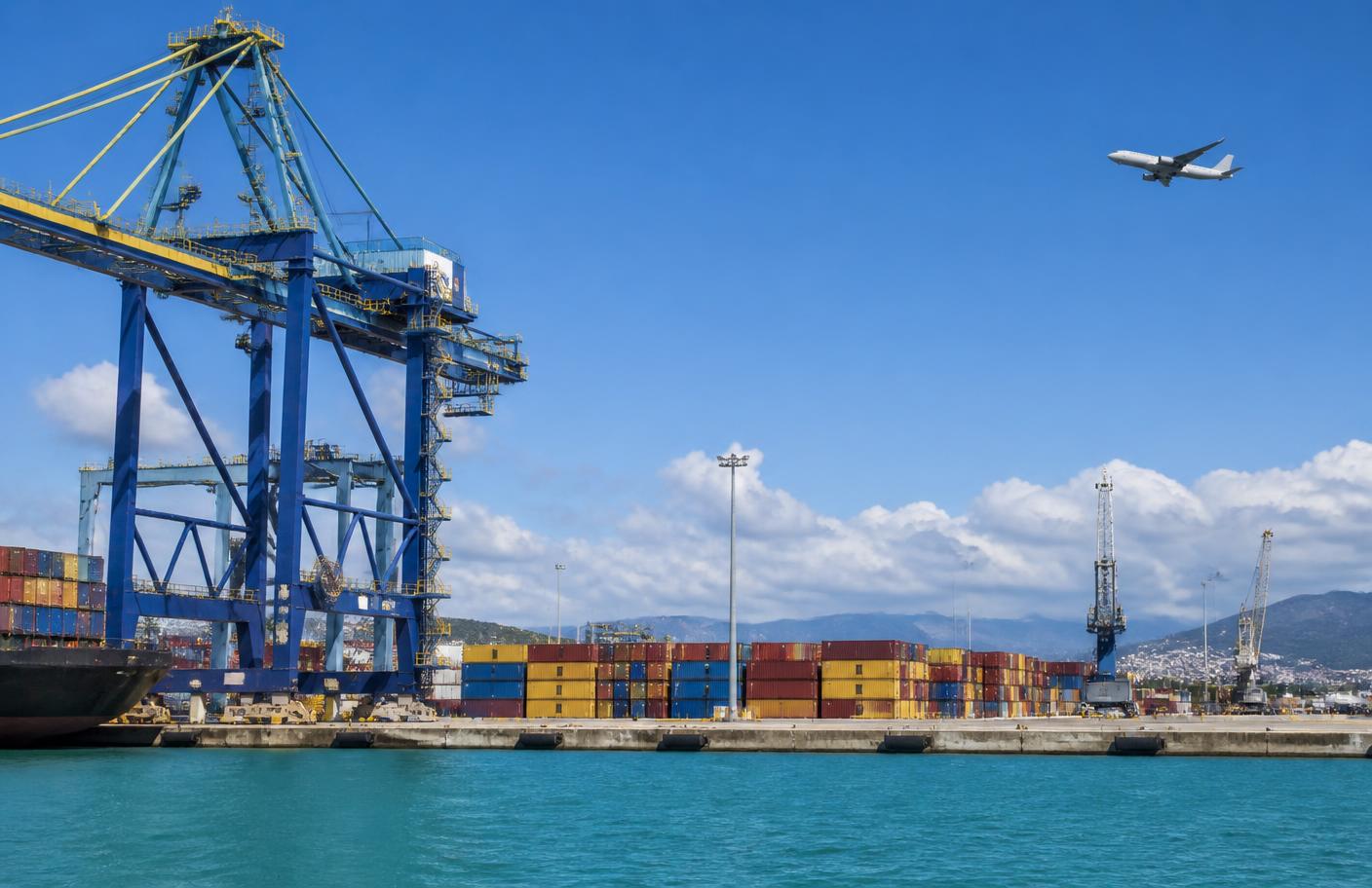 Container terminal cranes and stacked cargo containers at a Caribbean seaport